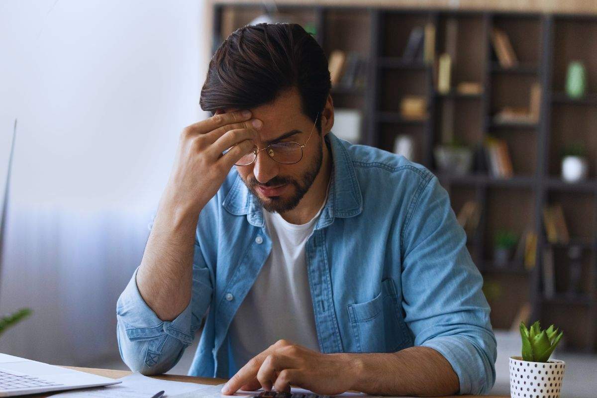 Uomo preoccupato dai pagamenti controlla i documenti
